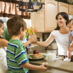 Mom giving kids breakfast.